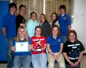 Students posing with award