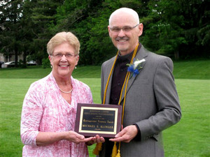 Couple posing with award