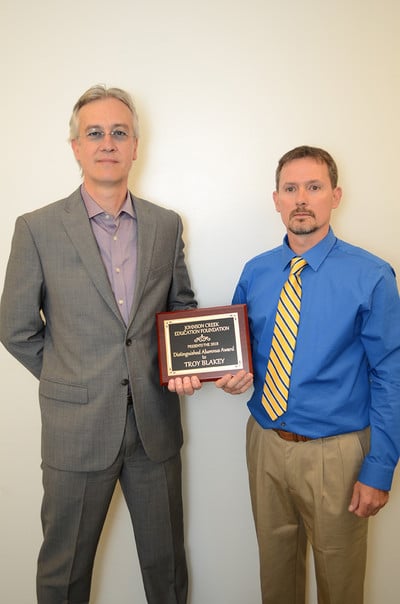 Troy Blakey receiving award from Ron Roehl